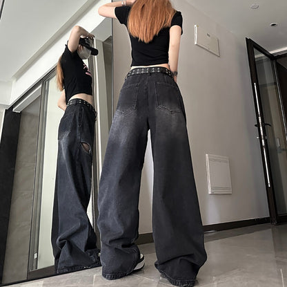 低い位置から撮影したブラックワイドデニムパンツの鏡ショット。膝周りから裾にかけて並ぶカットアウトスリットと厚底スニーカーの組み合わせ。